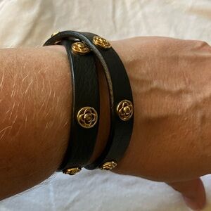 STELLA&DOT Black leather wrap bracelet with gold and rose gold details.